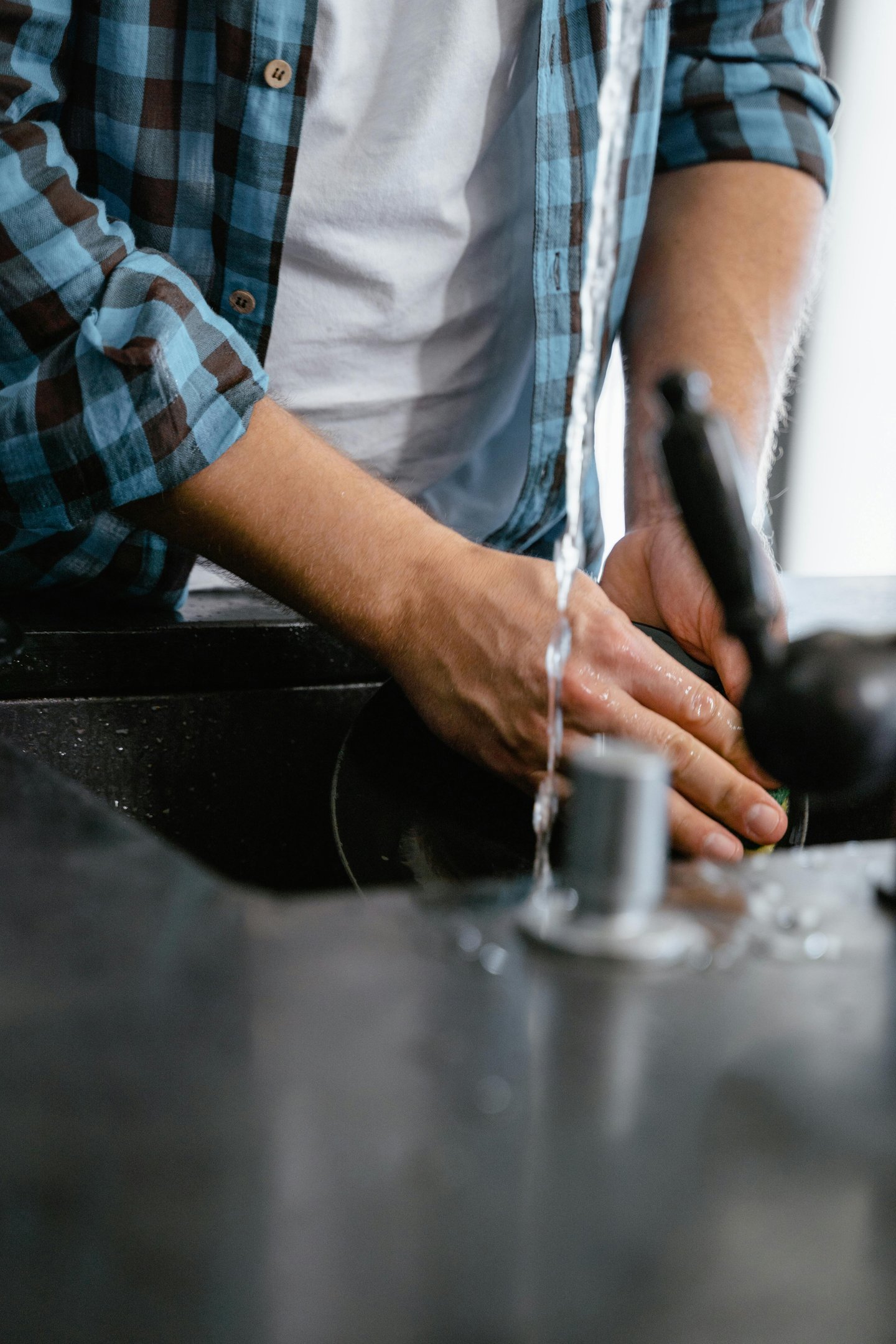 a man is washing his hands in a sink